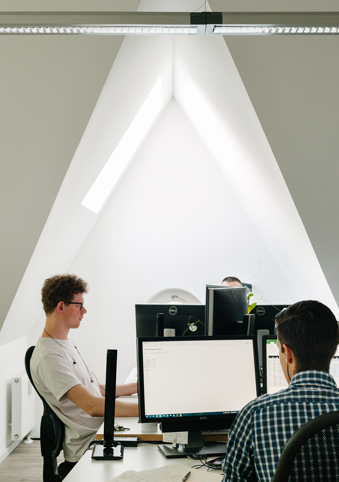 ctrl qs employees working at their desks in a bright office